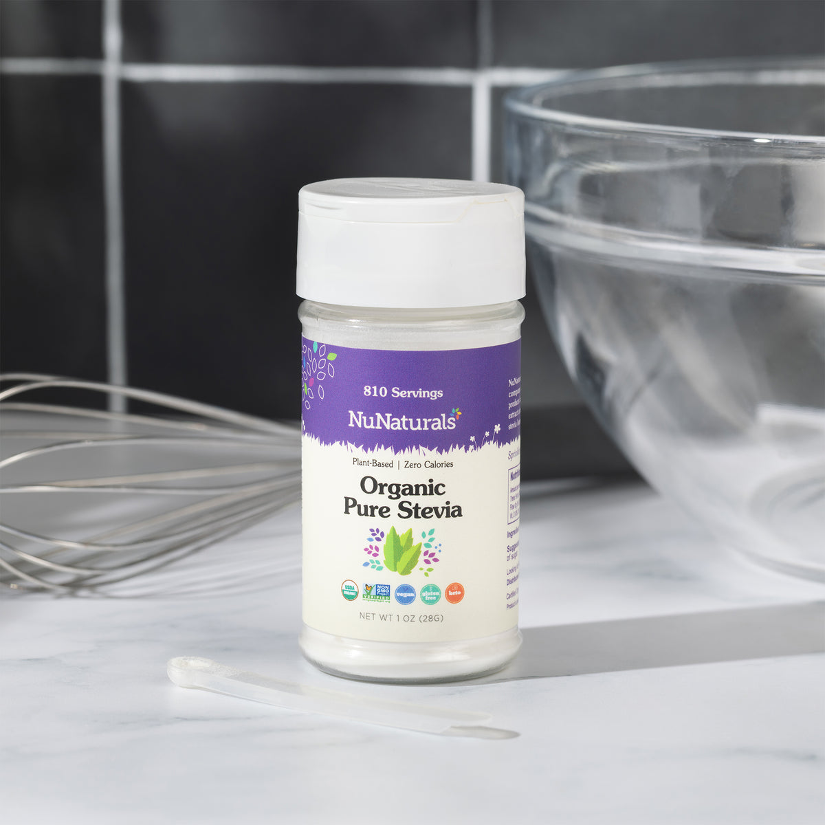 Organic Pure Stevia jar with its measuring scoop on a marble counter