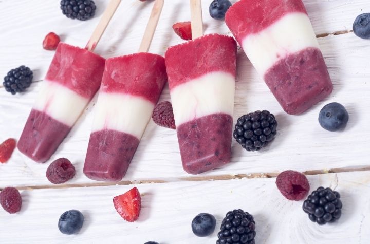 Red, white and blue stevia popsicles with blueberries and strawberries
