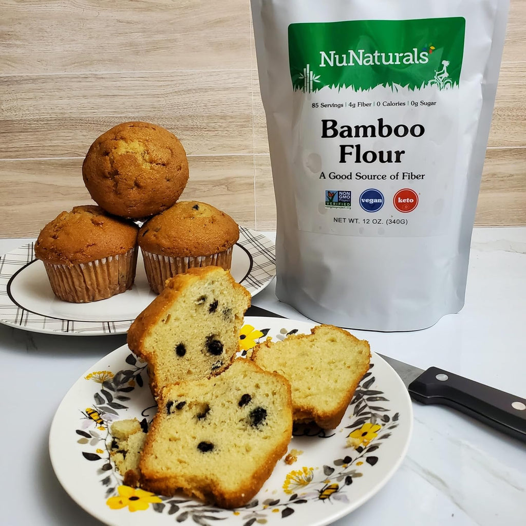 Bamboo Flour bag beside blueberry muffins and sliced blueberry loaf on a floral plate