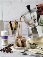 Organic Pure Stevia shaker beside an espresso pot pouring coffee over ice cream, with biscotti and coffee beans