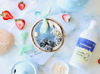 Vanilla Syrup 16 oz bottle partly in frame beside a coconut bowl of blue smoothie topped with blackberries and mermaid tails