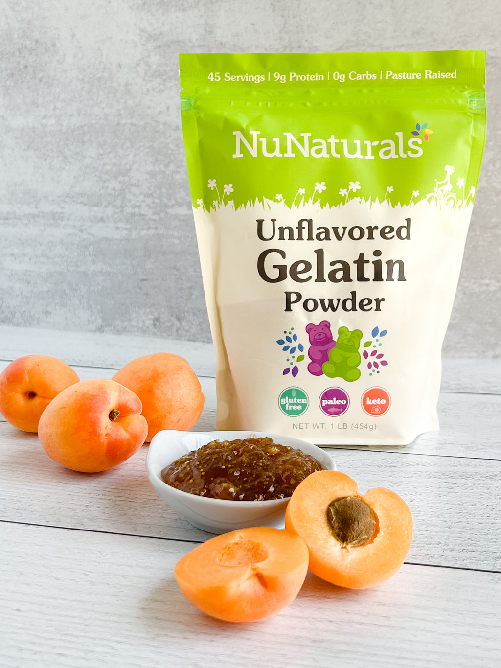 Unflavored Gelatin pouch, front label, beside a small bowl of apricot gelled spread and apricot halves