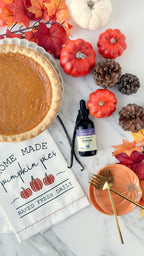 Vanilla Alcohol-Free Stevia 2 oz dropper bottle by a pumpkin pie, vanilla beans, mini pumpkins, and pine cones